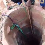 One of the officials of the state Fire Service trying to recover the corpse from the well in Saki.